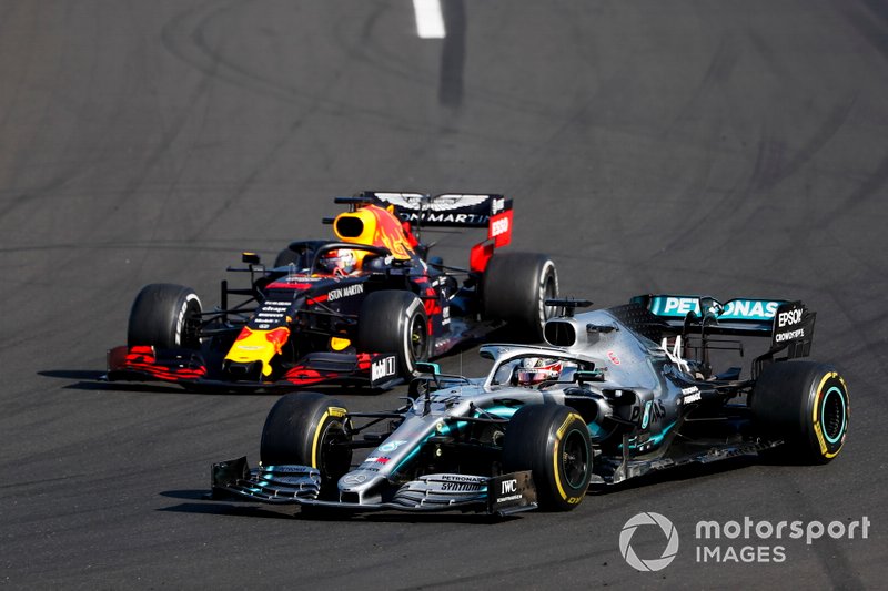 Lewis Hamilton, Mercedes AMG F1 W10 overtakes Max Verstappen, Red Bull Racing RB15 for the lead