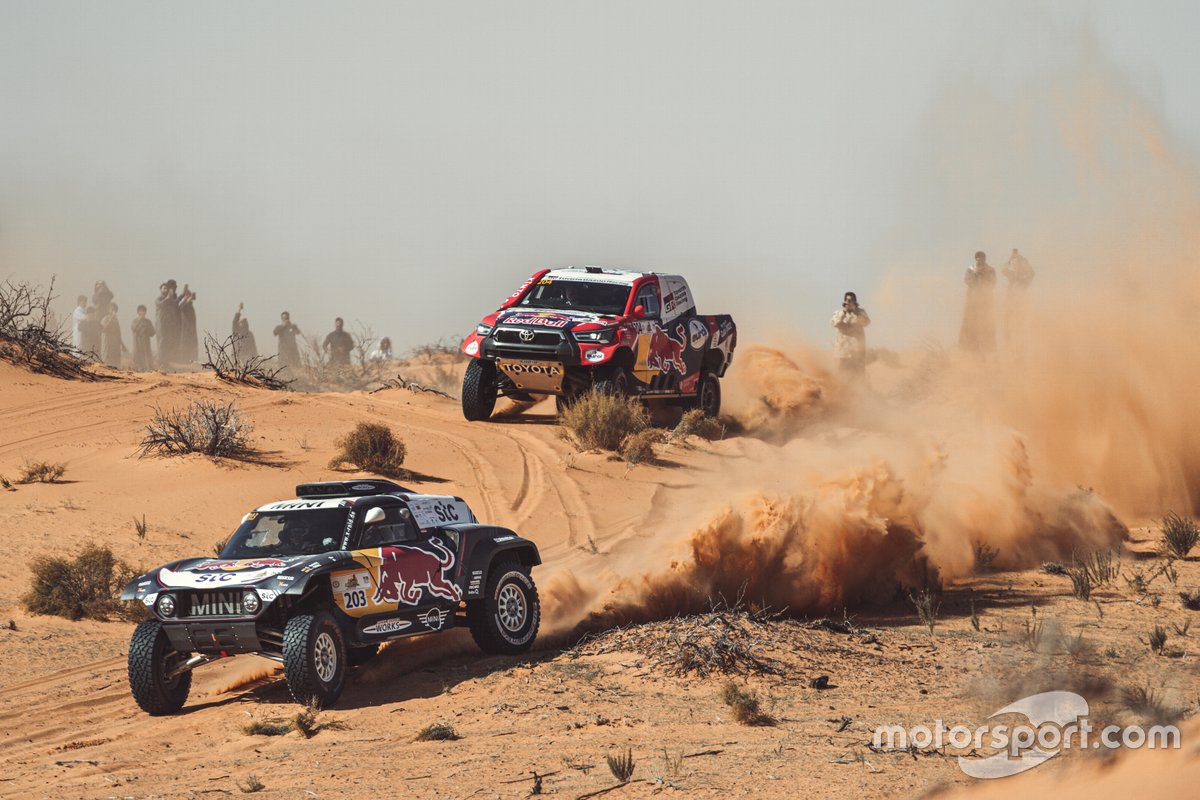 Pereli MINI X-Raid, Carlos Sainz, dan navigatornya, Lucas Cruz, diikuti oleh Nasser Al Attiyah dan co-driver Mathieu Baumel (Toyota Gazoo Racing) dalam Baja Hail 1.