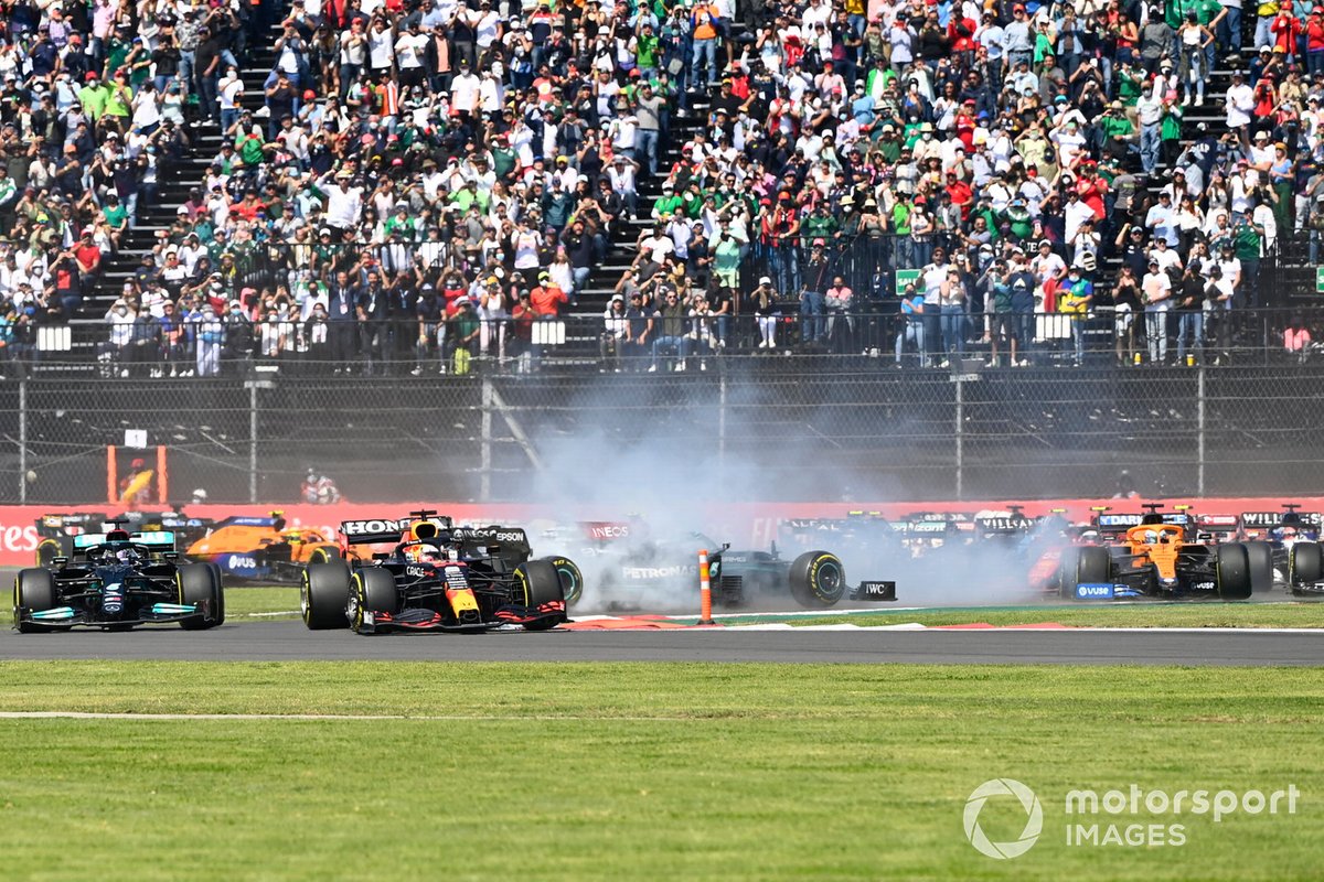 Max Verstappen, Red Bull Racing RB16B, Lewis Hamilton, Mercedes W12, as Valtteri Bottas, Mercedes W12, spins on the opening lap