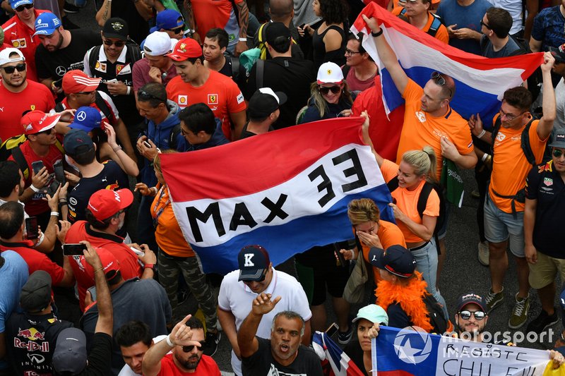 Fans celebrate and display banners after the race