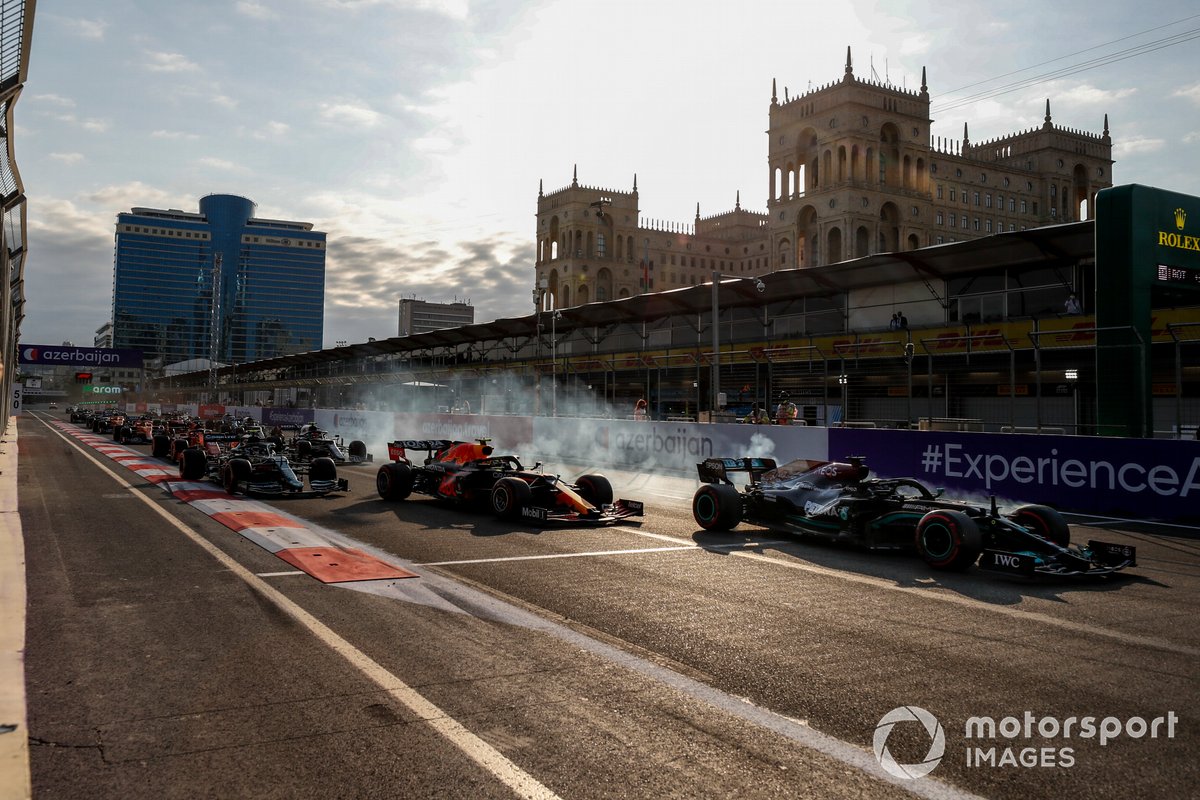 Lewis Hamilton, Mercedes W12 runs wide from Sergio Perez, Red Bull Racing RB16B at the restart of the race