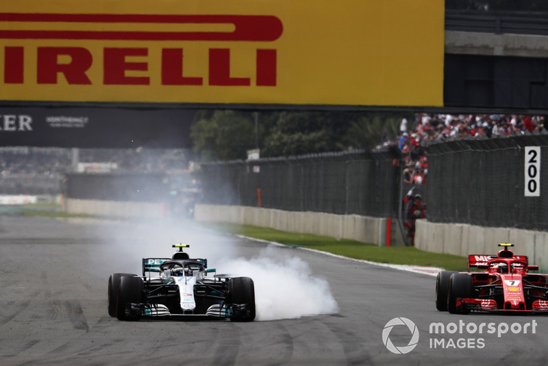 Valtteri Bottas, Mercedes AMG F1 W09 EQ Power+, locks his brakes whilst battling with Kimi Raikkonen, Ferrari SF71H