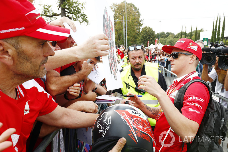 Kimi Raikkonen, Ferrari, signs autographs for his fans