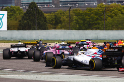 Kevin Magnussen, Haas F1 Team VF-18 Ferrari, Esteban Ocon, Force India VJM11 Mercedes, and Sergey Sirotkin, Williams FW41 Mercedes, in the middle of the pack at the start of the race