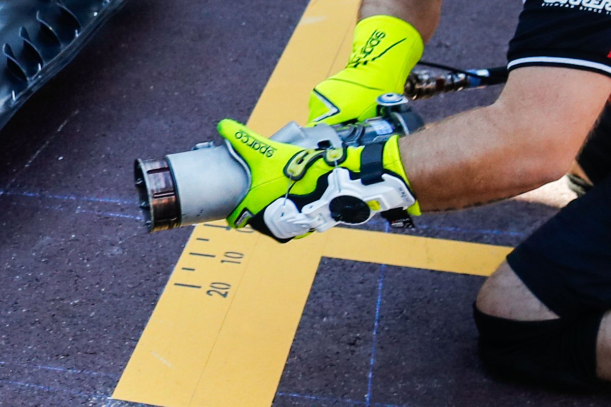 Dettaglio dell'eso-scheletro sul guanto di un meccanico Alfa Romeo al pit stop