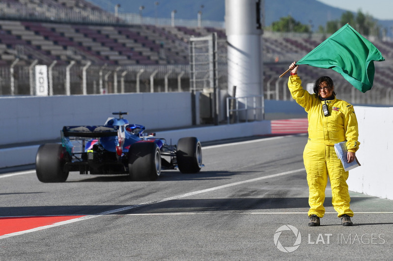 Marshal waves the green flag