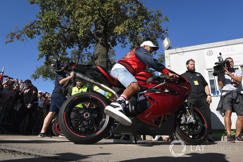 Lewis Hamilton, Mercedes AMG F1 arrives at the track on his motorbike