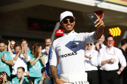 Lewis Hamilton, Mercedes AMG F1, takes a selfie as he celebrates winning the Constructors' Champions