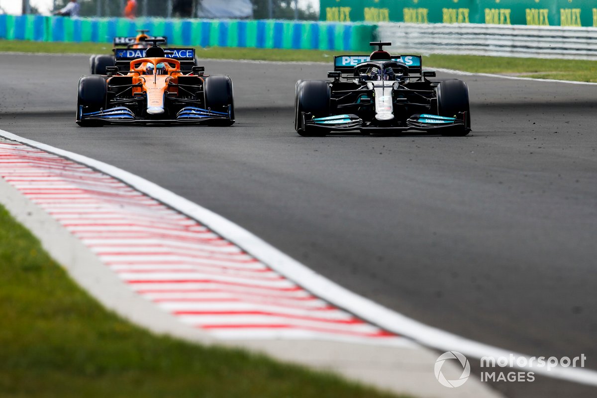 Lewis Hamilton, Mercedes W12, passes Daniel Ricciardo, McLaren MCL35M