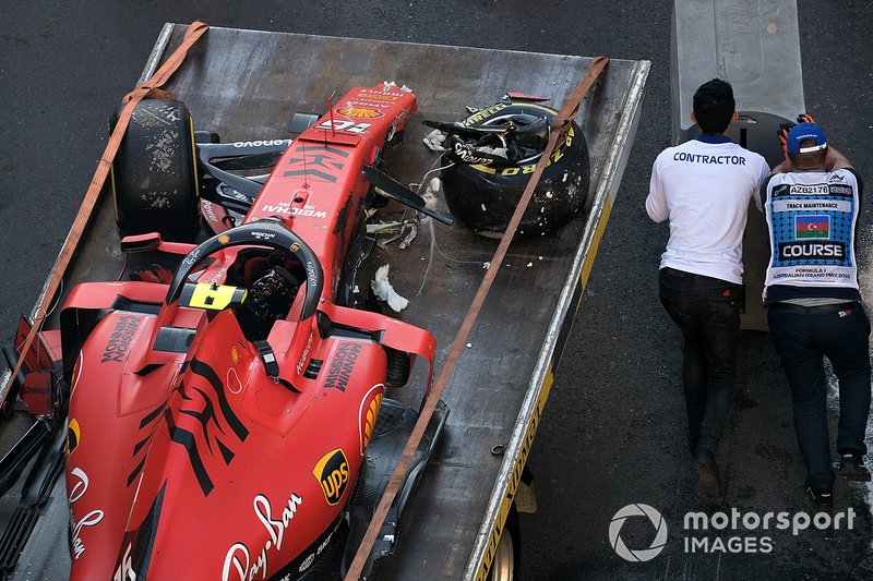 Crews remove the crashed car of Charles Leclerc, Ferrari SF90