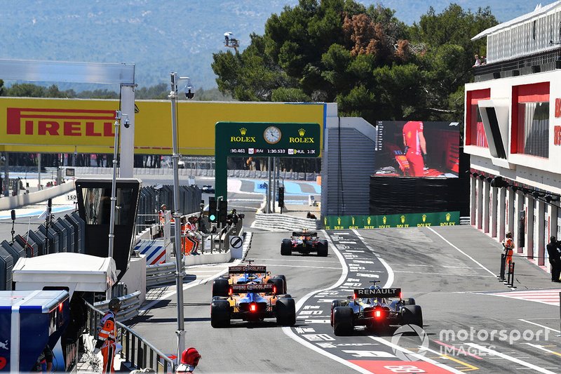 Pierre Gasly, Red Bull Racing RB15, Carlos Sainz Jr., McLaren MCL34, Lando Norris, McLaren MCL34, and Max Verstappen, Red Bull Racing RB15, leave the pits during Qualifying