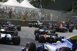 Marcus Ericsson, Sauber C36, brings up the rear of a midfield straggle at the start