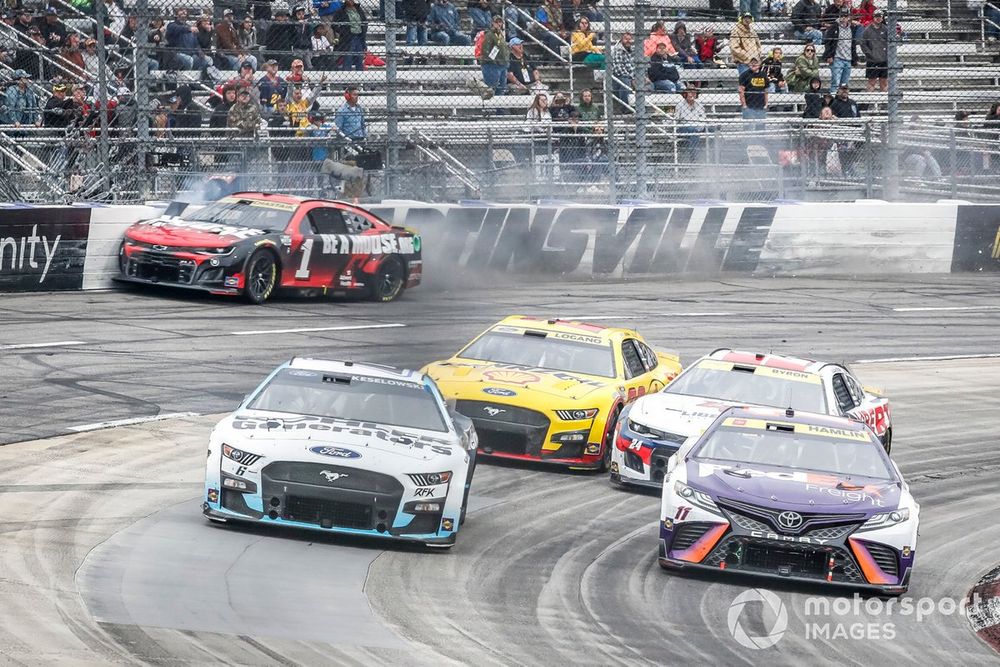 Ross Chastain, TrackHouse Racing, Moose Fraternity Chevrolet Camaro launches his car into the wall to speed around Turn 4 to pass Denny Hamlin, Joe Gibbs Racing, FedEx Freight Direct Toyota Camry