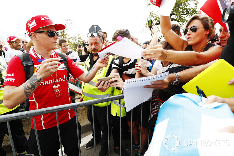 Kimi Raikkonen, Ferrari, signs autographs for his fans