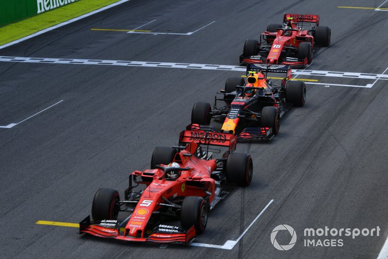 Sebastian Vettel, Ferrari SF90, leads Alexander Albon, Red Bull RB15, and Charles Leclerc, Ferrari SF90, at the end of the first Safety Car period