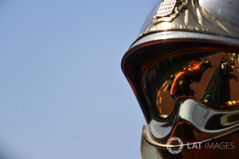 Fernando Alonso, McLaren MCL33 reflected in a fireman helmet