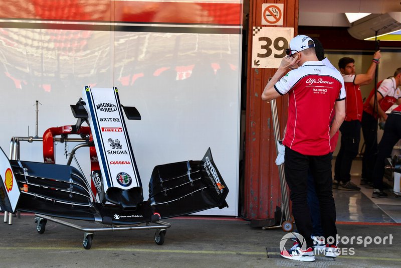 Kimi Raikkonen, Alfa Romeo Racing, examines a front wing