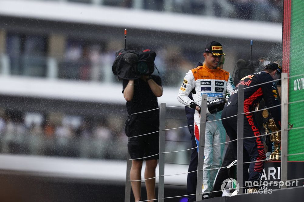 Lando Norris, McLaren, 2nd position, Max Verstappen, Red Bull Racing, 1st position, spray Champagne on the podium