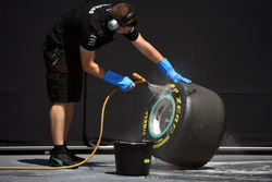 Mercedes AMG F1 mechanic cleans Pirelli tyre