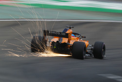 Sparks fly from the car of Fernando Alonso, McLaren MCL33 Renault