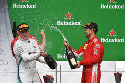 Valtteri Bottas, Mercedes-AMG F1 and Sebastian Vettel, Ferrari celebrate on the podium with the cham