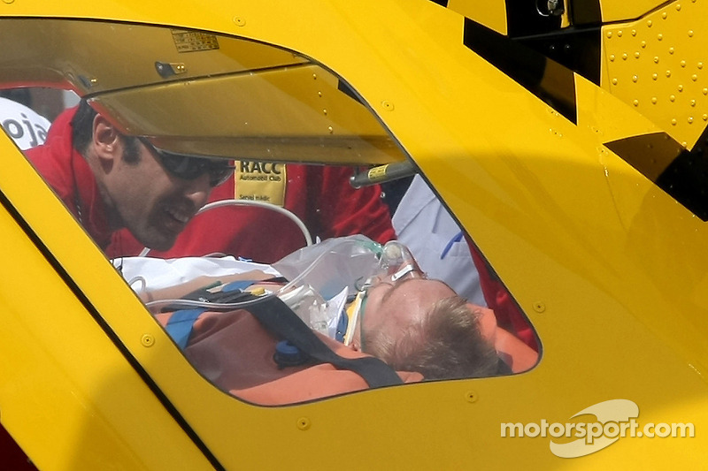 Heikki Kovalainen, McLaren Mercedes on a stretcher being loaded into a helicopter after crashing