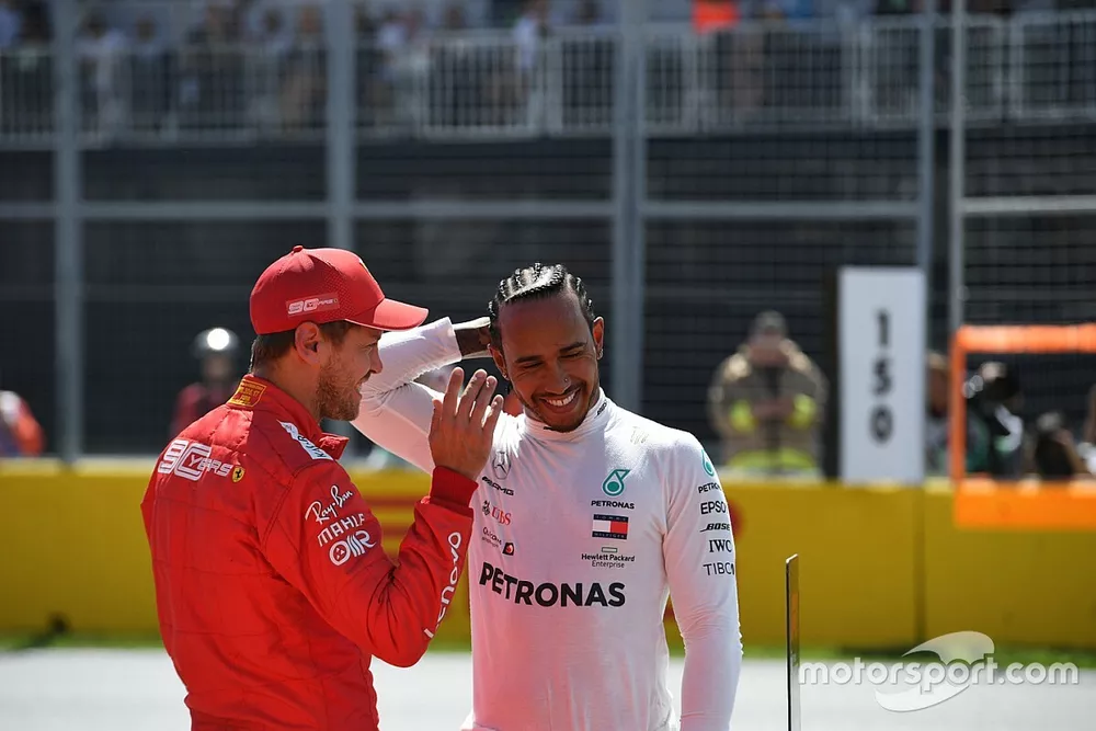 Pole man Sebastian Vettel, Ferrari, with Lewis Hamilton, Mercedes AMG F1, after Qualifying