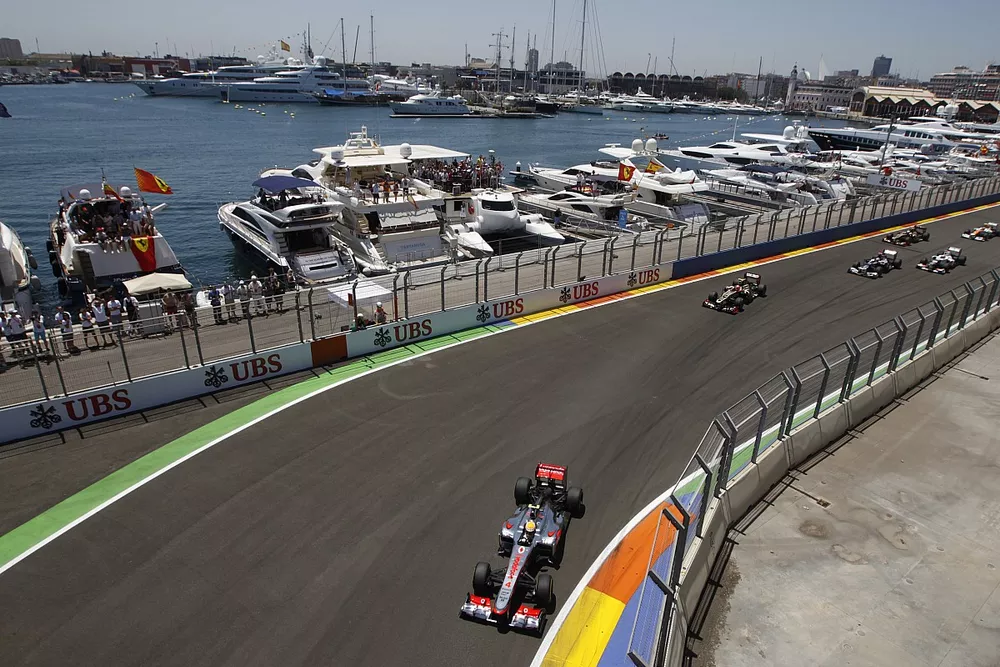 Lewis Hamilton, McLaren MP4-27 Mercedes, leads Romain Grosjean, Lotus E20 Renault.