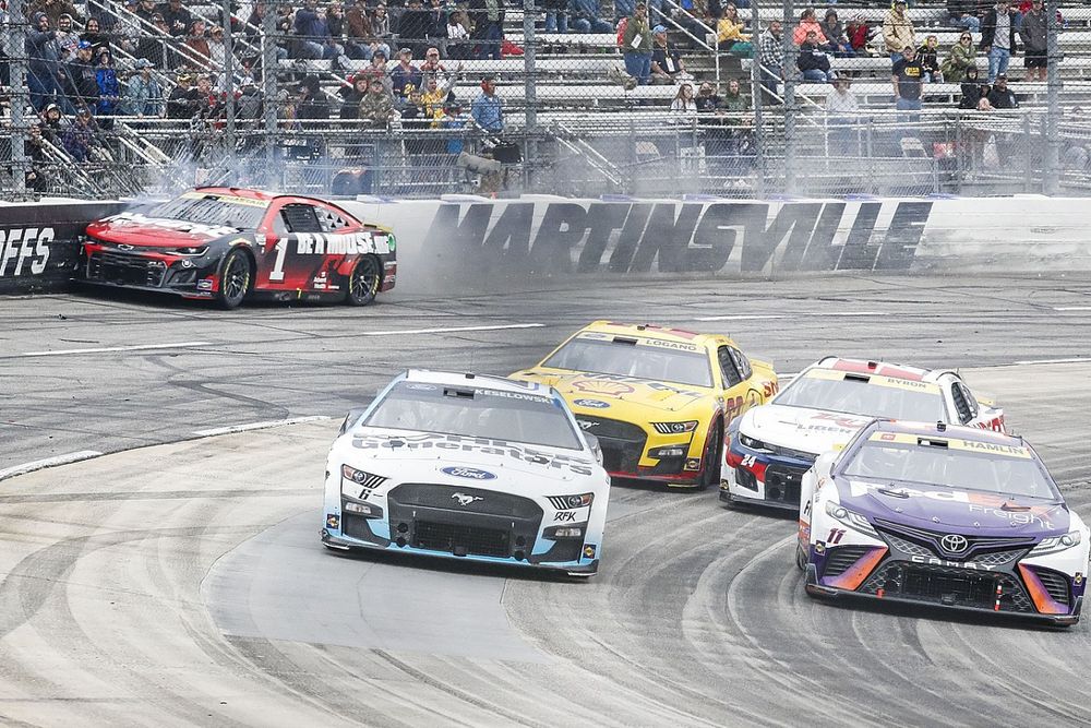 Ross Chastain, TrackHouse Racing, Moose Fraternity Chevrolet Camaro launches his car into the wall to speed around Turn 4 to pass Denny Hamlin, Joe Gibbs Racing, FedEx Freight Direct Toyota Camry