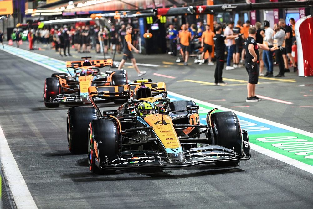 Lando Norris, McLaren MCL60, Oscar Piastri, McLaren MCL60, in the pit lane