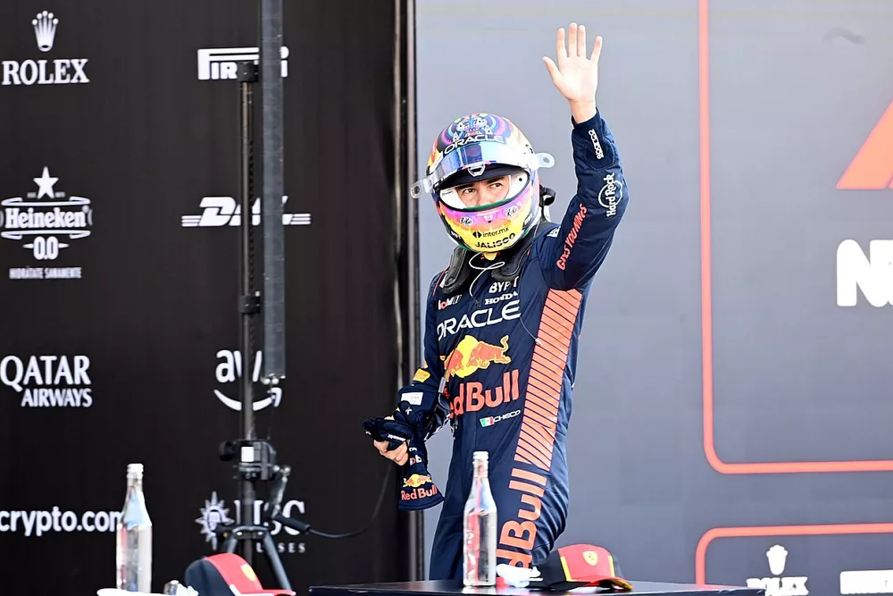 Sergio Perez, Red Bull Racing RB19, waves at the crowds