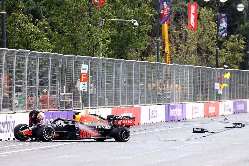 Max Verstappen, Red Bull Racing, climbs out of his car after crashing out from the lead