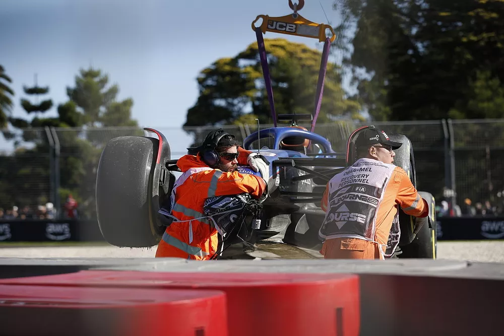 Marshals remove the damaged car of Alex Albon, Williams FW45, from the circuit