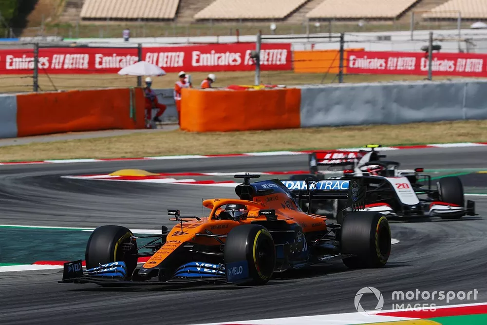Carlos Sainz Jr., McLaren MCL35, leads Kevin Magnussen, Haas VF-20