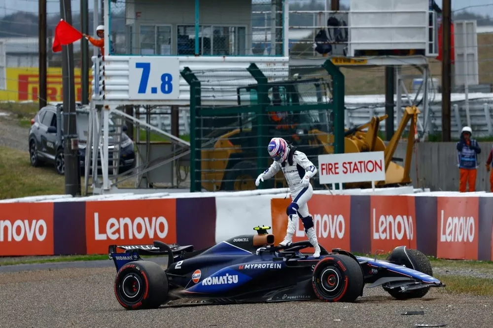 Logan Sargeant, Williams FW46, climbs out of his damaged car after a crash in FP1
