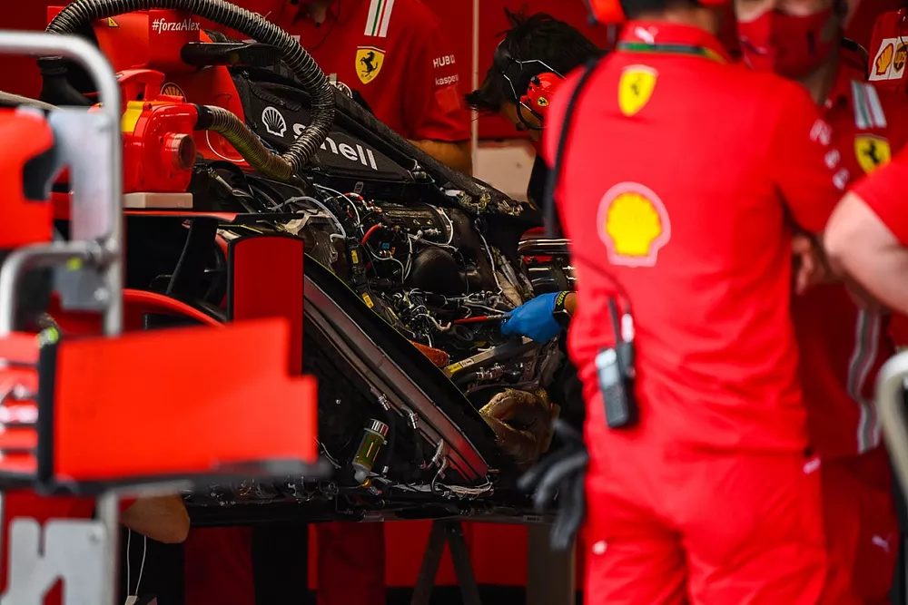 Ferrari mechnanics at work in the team's garage and SF1000 engine detail