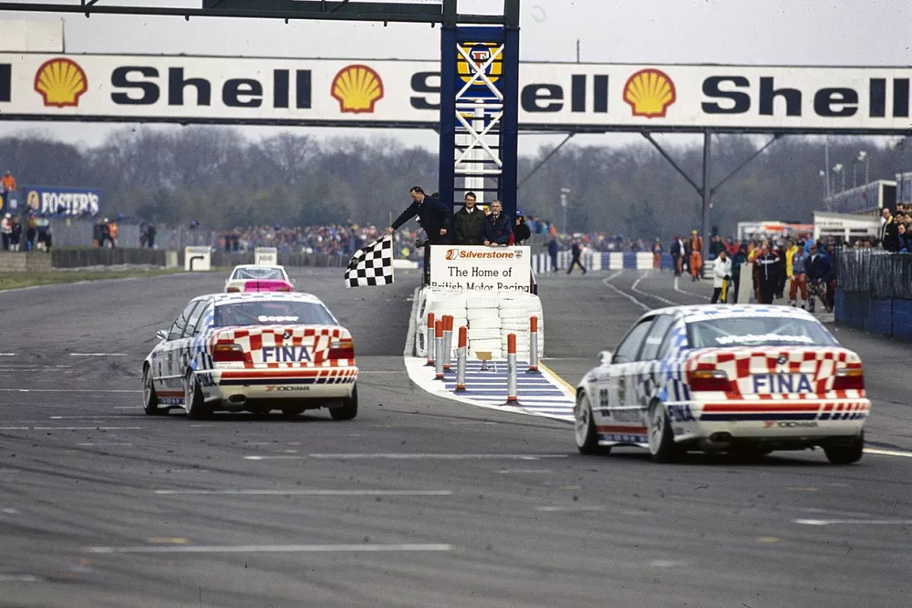 Steve Soper, BMW Motorsport Team, BMW 318i, leads Joachim Winkelhock, BMW Motorsport Team, BMW 318i, across the line to take the chequered flag