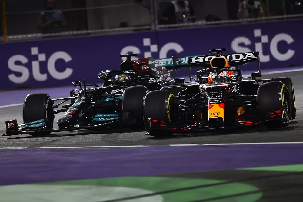 Max Verstappen, Red Bull Racing RB16B, and Lewis Hamilton, Mercedes W12, make contact as they battle for the lead