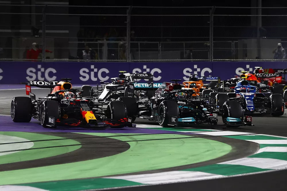 Max Verstappen, Red Bull Racing RB16B, runs off the track while battling with Lewis Hamilton, Mercedes W12 at the restart