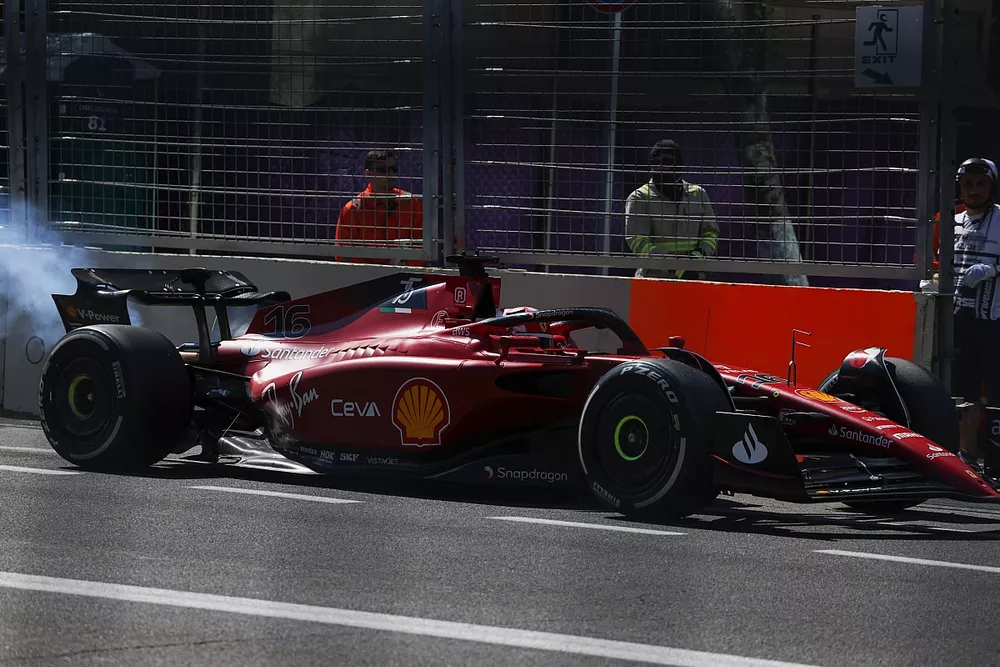 Charles Leclerc, Ferrari F1-75, limps back to the pit trailing smoke
