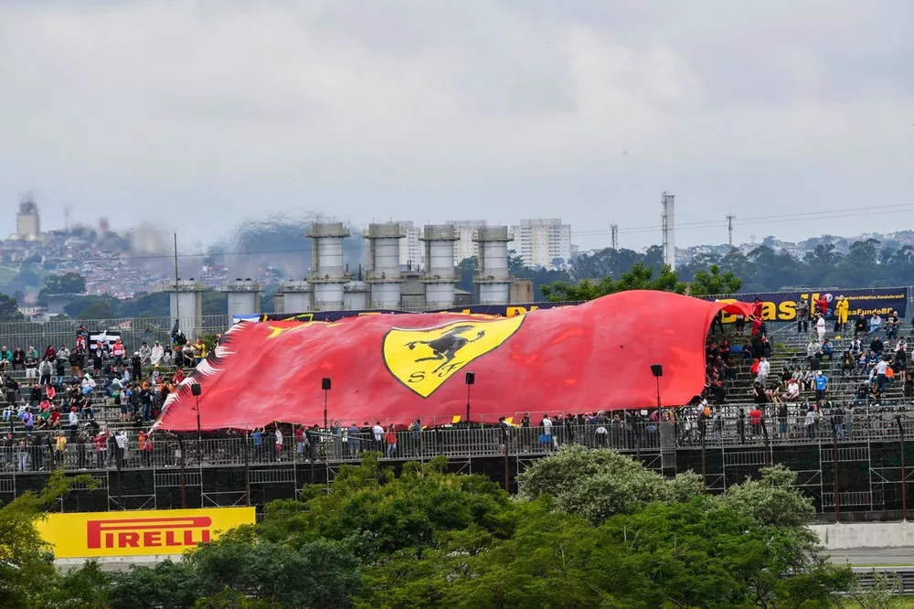 The crowd unveils a huge Ferrari flag