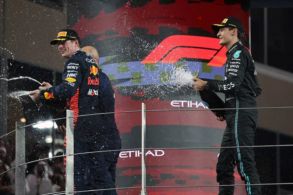 Max Verstappen, Red Bull Racing, 1st position, George Russell, Mercedes-AMG, 3rd position, spray Champagne on the podium