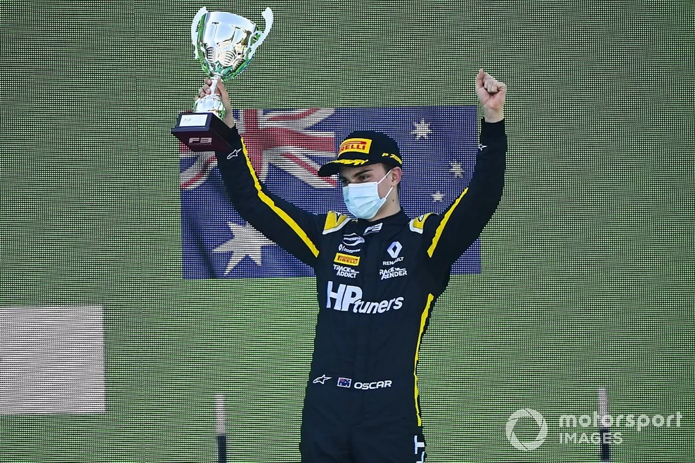 Oscar Piastri, Prema Racing celebrates on the podium with the trophy