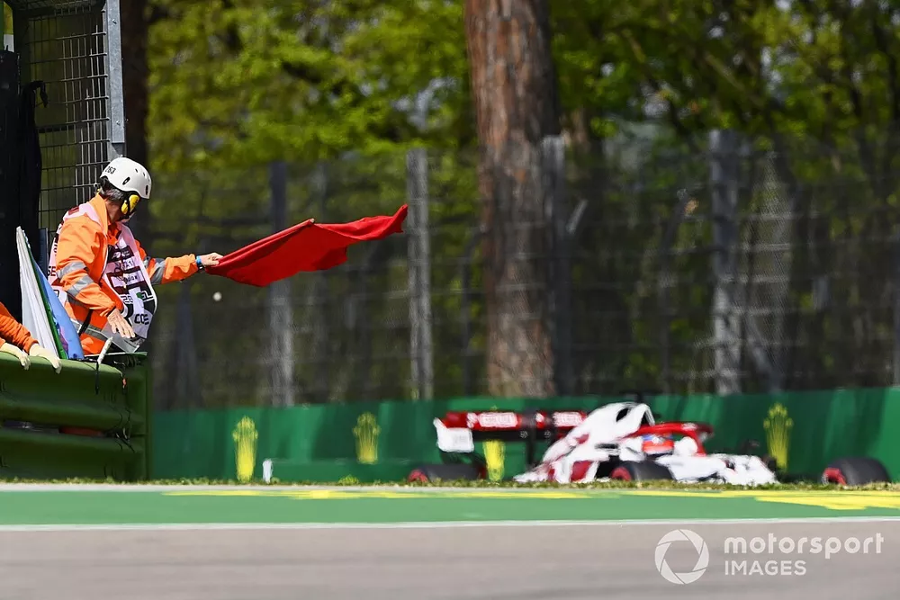 Marshals wave the red flag as Kimi Raikkonen, Alfa Romeo Racing C41, passes
