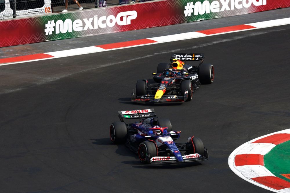 Liam Lawson, VCARB 01, leads Sergio Perez, Red Bull Racing RB20