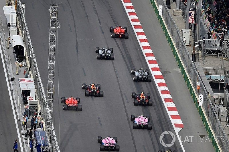 Sebastian Vettel, Ferrari SF71H leads Lewis Hamilton, Mercedes-AMG F1 W09 EQ Power+ at the start of the race