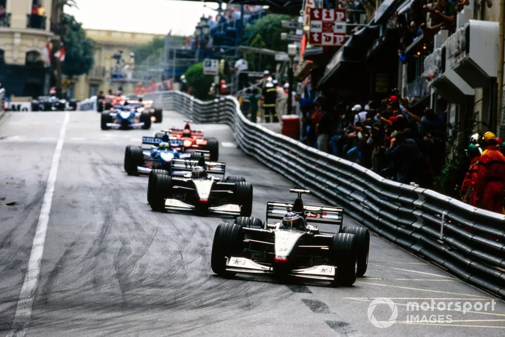 Mika H&auml;kkinen, McLaren MP4-13 Mercedes, leads David Coulthard, McLaren MP4-13 Mercedes, Giancarlo Fisichella, Benetton B198 Playlife, and Michael Schumacher, Ferrari F300, into Mirabeau on the opening lap.