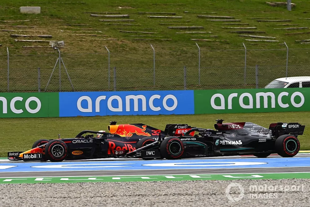 Max Verstappen, Red Bull Racing RB16B, passes Sir Lewis Hamilton, Mercedes W12, for the lead on the opening lap
