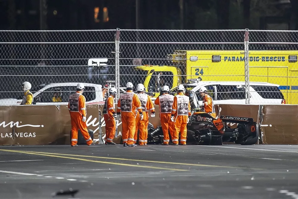 Marshals assist Lando Norris, McLaren MCL60, after he crashes out