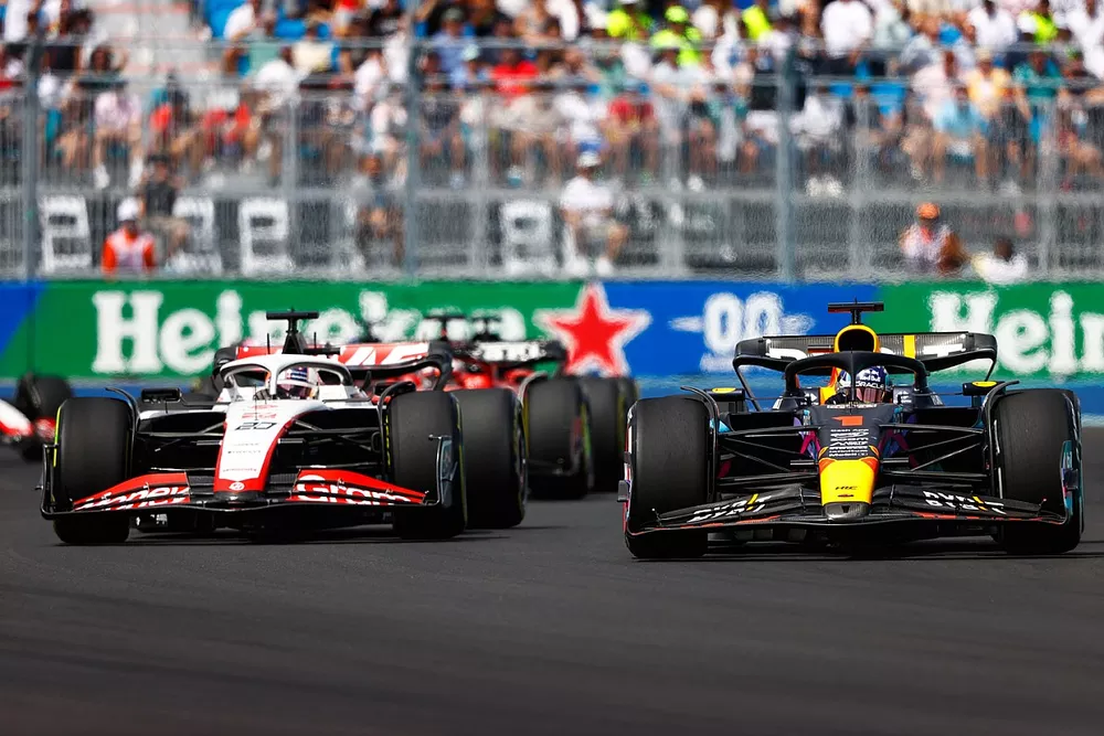 Max Verstappen, Red Bull Racing RB19, battles with Kevin Magnussen, Haas VF-23